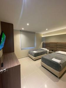 Ένα ή περισσότερα κρεβάτια σε δωμάτιο στο Apto Grand- Ithiel