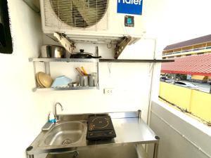 a kitchen with a sink and a air conditioner at Patong Canal Villa R203 in Patong Beach