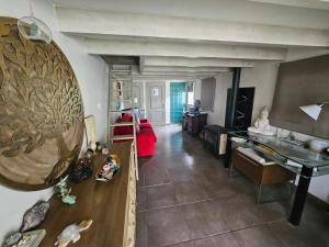 a living room with a piano and a red couch at Duplex Piscine Climatisation in Vendémian