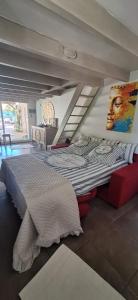 a bedroom with a large bed with a painting on the wall at Duplex piscine calme in Vendémian