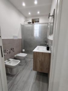 a bathroom with a toilet and a sink and a shower at La Casetta di Nonno Settimo in Palermo +16 photos