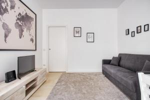a living room with a couch and a television at New and bright flat close to Navigli area - Cermenate B4 in Milan