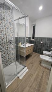 a bathroom with a shower and a toilet and a sink at DOMUS AISA appartamenti Formia centro in Formia