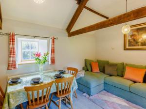 a living room with a table and a couch at 2 bed in Chulmleigh 87668 in Chulmleigh