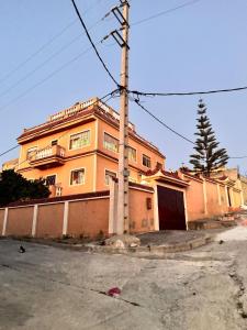 an orange building with a pole in front of it at Chalet, para disfrutar de un amanecer, paz y tranquilidad en familia 