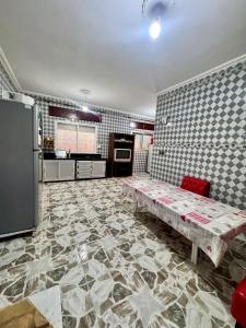 a kitchen with a table in the middle of a room at Chalet, para disfrutar de un amanecer, paz y tranquilidad en familia  +15 photos