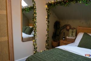 a bedroom with a bed and a mirror at Upbeat Jungle Loft Apartment in Derby