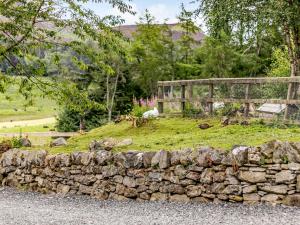 a stone wall in front of a field with a fence at 1 Bed in Blacklunans CA361 in Cray +8 photos