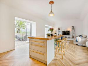 a kitchen and living room with a counter and a table at 3 Bed in Glen Clova 75284 in Kirriemuir