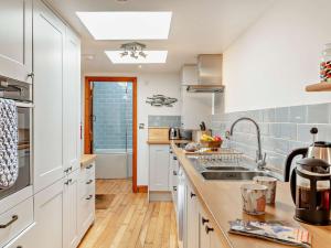 a kitchen with white cabinets and a sink at 2 bed property in Appledore Devon COCKL in Appledore