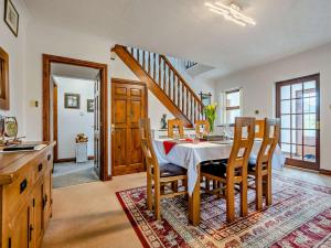 a kitchen and dining room with a table and chairs at 4 Bed in Troutbeck nr Ullswater SZ256 in Troutbeck