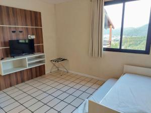 Ein Bett oder Betten in einem Zimmer der Unterkunft Morro do Sol Hotel & Eventos