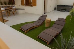 a row of chairs sitting on a patch of grass at Malakion Lux Seaside Jacuzzi in Malaki +25 photos