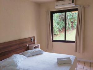 Ein Bett oder Betten in einem Zimmer der Unterkunft Morro do Sol Hotel & Eventos
