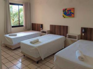 Ein Bett oder Betten in einem Zimmer der Unterkunft Morro do Sol Hotel & Eventos