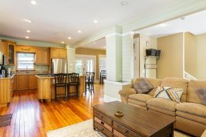 a living room with a couch and a table at Home with Garage, Hot Tub, near OSU & Short North in Columbus