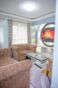 a living room with a couch and a table at SpringStone executive apartment A15 in Ongata Rongai 
