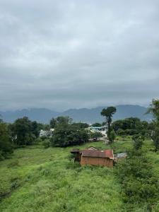 a field with a tent in the middle of a field at Shelter and sky in Dehradun