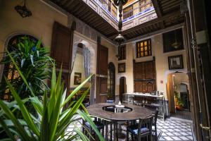 a room with tables and chairs in a building at Saphiryad in Fez