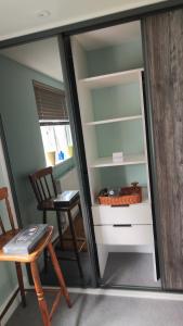 a room with a desk and a chair and a table at Quiet Loft Double Room forty-five minutes by train to London Liv Street in Braintree