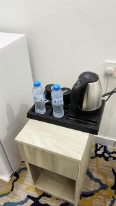 a table with two water bottles on top of it at فندق برادايس لاند الزهراء Paradis Land Hotel ALzhra in Az Zahrāʼ +19 photos