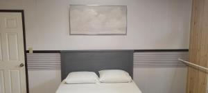 a bedroom with a bed with two pillows on it at WhiteCourt in Abbotsford