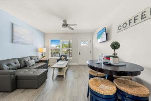 a living room with a couch and a table at Sun and Sea By Beachside Management in Siesta Key