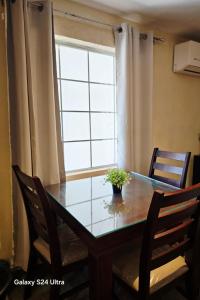 a dining room table with chairs and a window at Hotel Express Inn in Sabinas +7 photos