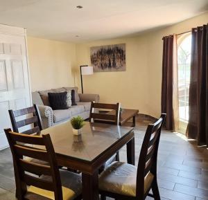 a living room with a table and chairs and a couch at Hotel Express Inn in Sabinas