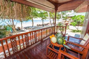 a balcony with a table with fruits and vegetables on it at Lamai Coconut Beach Resort in Lamai