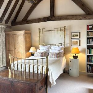 a bedroom with a bed and a book shelf at Woolmarket House in Kings Lynn