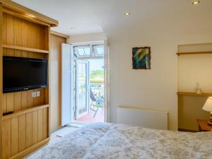 a bedroom with a bed and a sliding glass door at 2 Bed in Instow 78256 in Instow