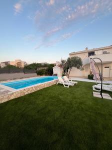 a backyard with a swimming pool and a slide at Apartments PUPA in Povljana