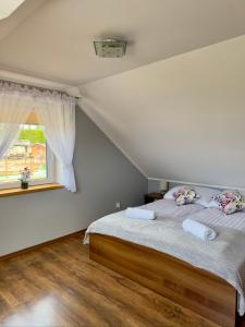 a bedroom with a bed and a window at Osada Vikinga in Studzienice +65 photos