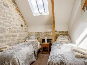 two beds in a room with a brick wall at 2 Bed in Glastonbury 79122 in Glastonbury
