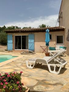 a villa with a swimming pool and a house at Villa provençale La Banisté in Saint-Cézaire-sur-Siagne