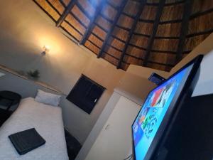 a small room with a television and a bed in it at Afpak in Barberton