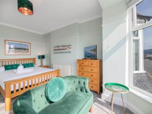 a bedroom with a bed and a couch at 3 bed in Aberdovey DY053 in Aberdyfi