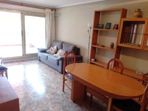 a living room with a table and a couch at Van-Dyck, ESC-4, 6-24 PK 18 in Cullera