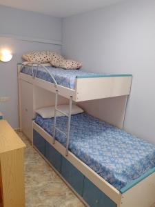 two bunk beds in a room with a table at Van-Dyck, ESC-4, 6-24 PK 18 in Cullera +17 photos