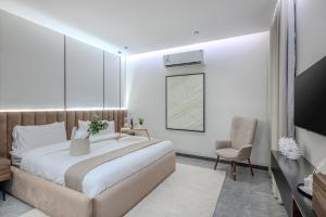 a bedroom with a large bed and a chair at Super Luxury SweetHome in Medina +12 photos