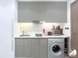 a white kitchen with a sink and a washing machine at Urban Charm Studio with Balcony in Azizi Riviera in Dubai