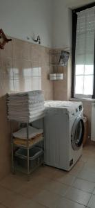 a kitchen with a washing machine and a counter at Casa al lago in Lido Di Fondi