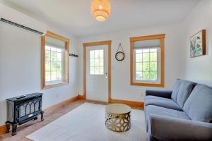 a living room with a couch and a table at The Laurel Leaf at Annes Windy Poplars in Cavendish