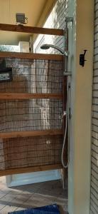 a shower in a room with a wall at Casa al lago in Lido Di Fondi +7 photos