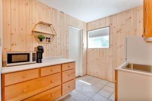 a kitchen with a microwave and a refrigerator at The Laurel Leaf at Annes Windy Poplars in Cavendish