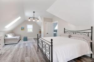 a bedroom with a large bed and a couch at The Euphrates in Cavendish