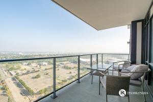 a balcony with chairs and a table and a view at 28th Floor High Rise Apartment Near Stampede Sleeps 4 with Free Secure Parking in Calgary