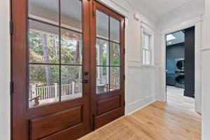 a large wooden door in a room with a balcony at 3290 Coon Hollow in Seabrook Island