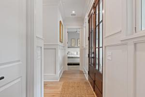 a hallway of a home with white walls and wood floors at 3290 Coon Hollow in Seabrook Island
